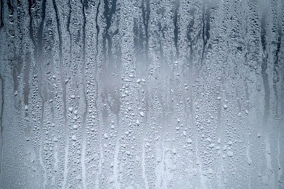 Why is there condensation on the inside of my glass door bottle cooler?